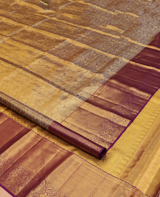 Gleaming Wine Kanchipuram Silk Saree, Gracefully Embellished with Jacquard Design All Over Its Body, Highlighted by a Zari Border of Thilakam, Muthu, Kathir, Mayil Kann, and Mayil Designs, and Pallu of Jaal Designs, and Paired with a Matching Blouse