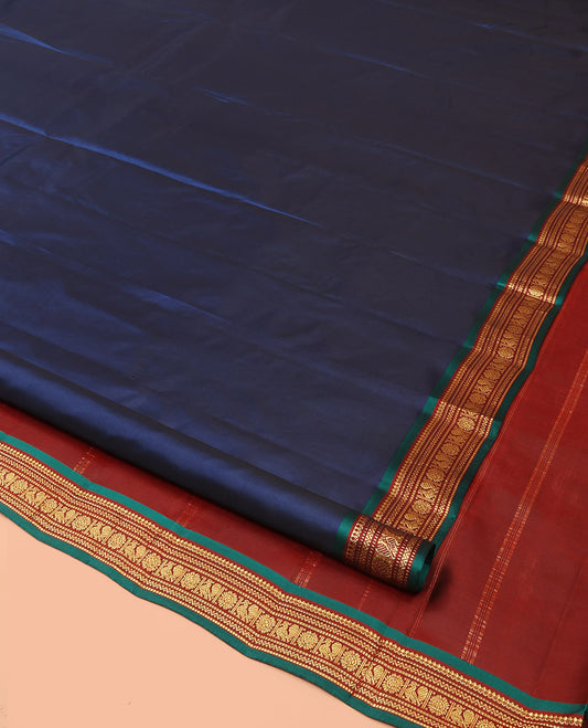 Blue Plain Kanchipuram Silk Saree, Complemented by a Contrast Border of Thilakam Mokku, Muthu, Neli, and Annam Chakram Designs, Zari-Woven Pallu, and Paired with a Contrast Blouse