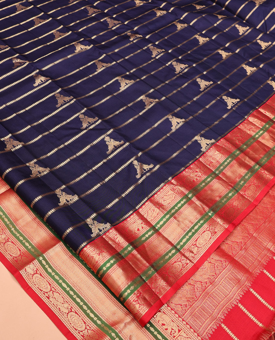 Blue Vasundhara Silk Saree, Accentuated with Zari Buttas and Stripes All Over Its Body, Complemented by a Contrast Border of Elephant, Mayil, and Chakram Designs, a Grand Pallu, and Paired with a Contrast Blouse