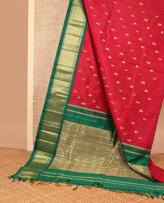 Red buttas kancheepuram silk saree with contrast korvai border of banaras, thilakam mokku, kuyil kann design & floral design pallu