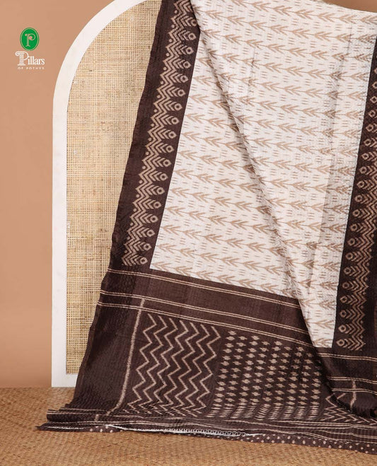 White ikat-style printed Litchi crushed saree, contrast brown ikat border, pallu of ikat chevron & dots & ikat printed blouse