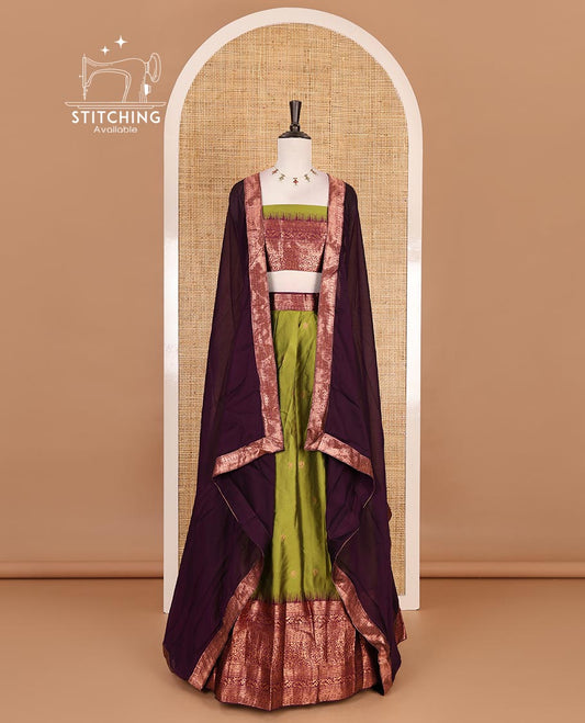 Leaf green taffeta silk half saree, zari buttas with contrast purple traditional zari border, matching zari blouse, and contrast plain zari border dhavani