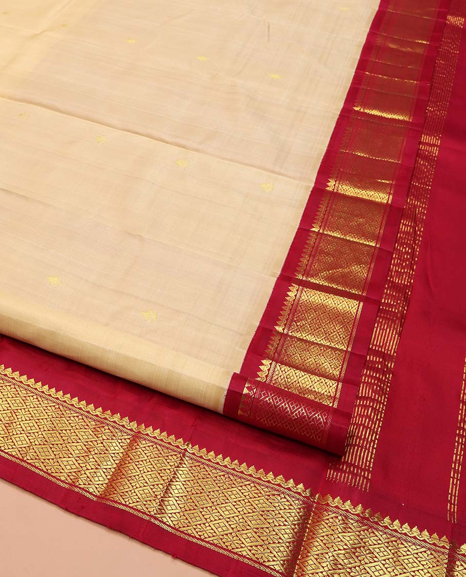 Sandal Kanchipuram Silk Saree, Sparsely Woven with Zari Buttas on Its Body, Complemented by Contrast One-Sided Border of Thilakam Mokku, and Jaal Designs, Pallu of Zari Designs, and Comes Without a Blouse