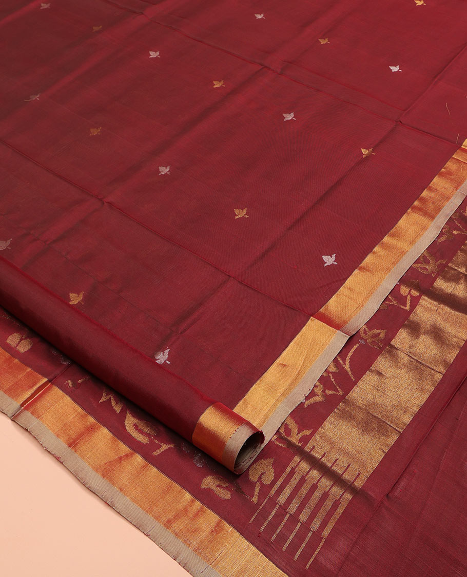 Maroon Uppada Silk Saree, Adorned with Zari Buttas All Over Its Body, Complemented by a Contrast Plain Border, Pallu Features Floral Jaal Designs, and Paired with a Matching Blouse