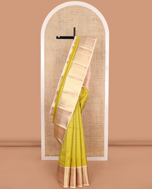 Yellow zari buttas and micro-checked Vasundhara silk mix saree, contrast border of thilakam mokku, banaras, paisa, mayil, banaras, and zari design, and peacock feather motifs pallu