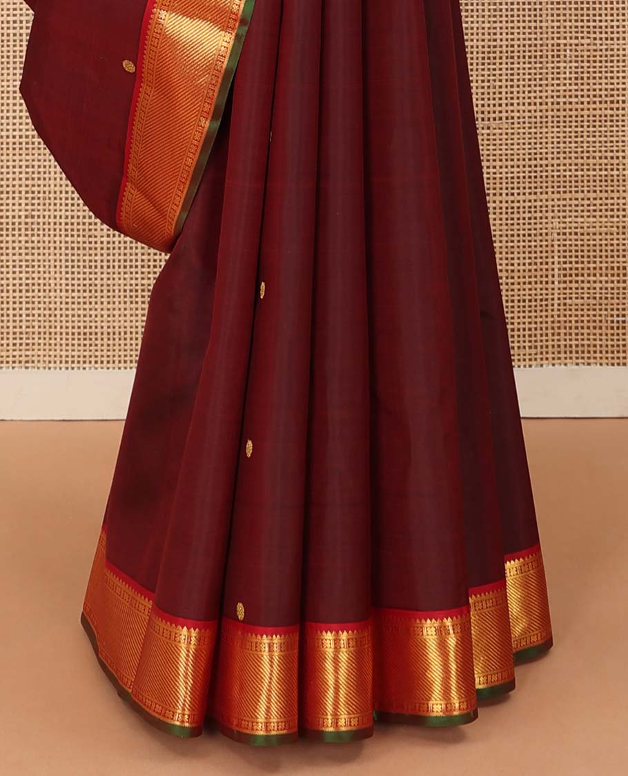 Maroon mayil poun buttas Kanchipuram silk saree, contrast border of rekku, banaras, cross kamalam, and zari stripes, and zari rich jaal pallu