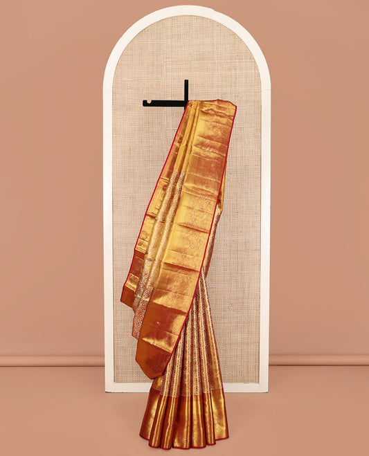 Red Kanchipuram Silk Saree, Opulently Embellished with Zari Jacquard Design All Over Its Body, Highlighted by a Zari Border of Thilakam Mokku, Muthu, Mayil Kann, and Manga Designs, and Pallu of Mughal-Style Designs, and Paired with a Matching Blouse