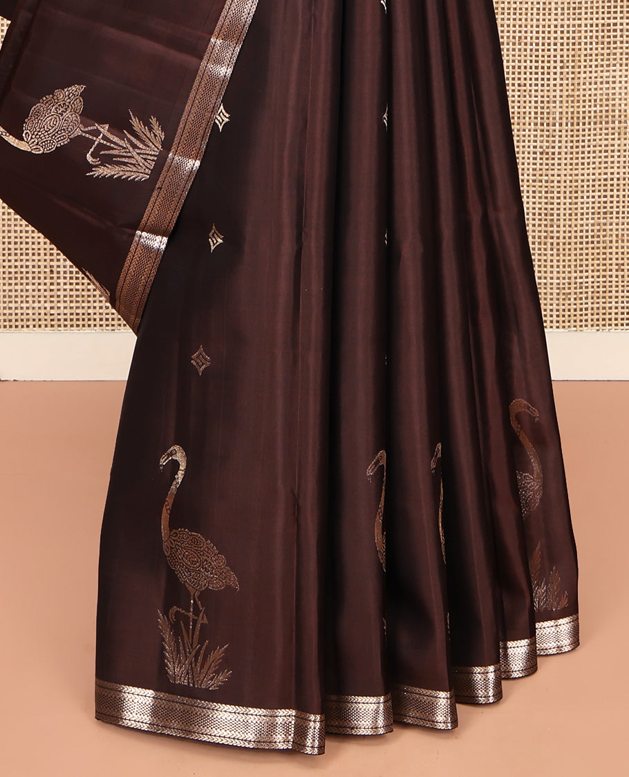 Brown Mayuri Soft Silk Saree, Spotlighted with Zari Buttas All Over Its Body, Highlighted by Piping Zari Border, Intricately Designed Pallu and Paired with a Matching Blouse