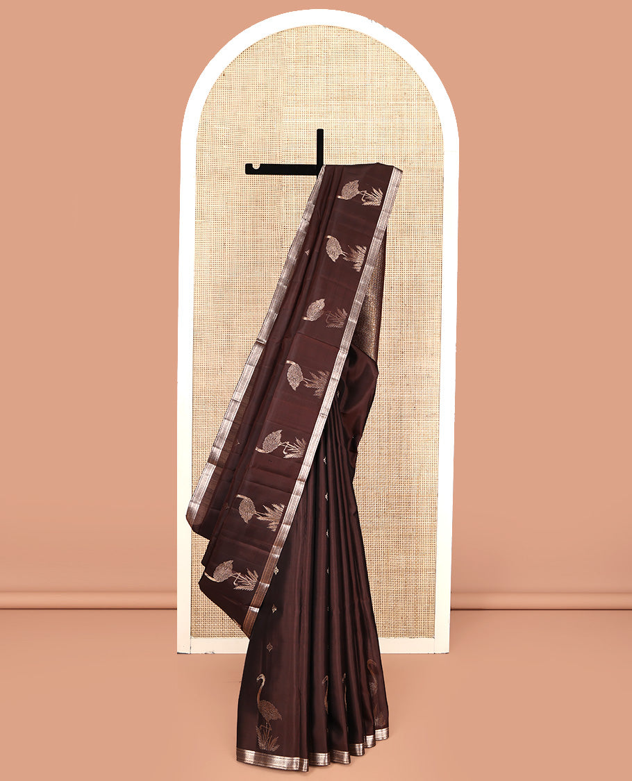 Brown Mayuri Soft Silk Saree, Spotlighted with Zari Buttas All Over Its Body, Highlighted by Piping Zari Border, Intricately Designed Pallu and Paired with a Matching Blouse