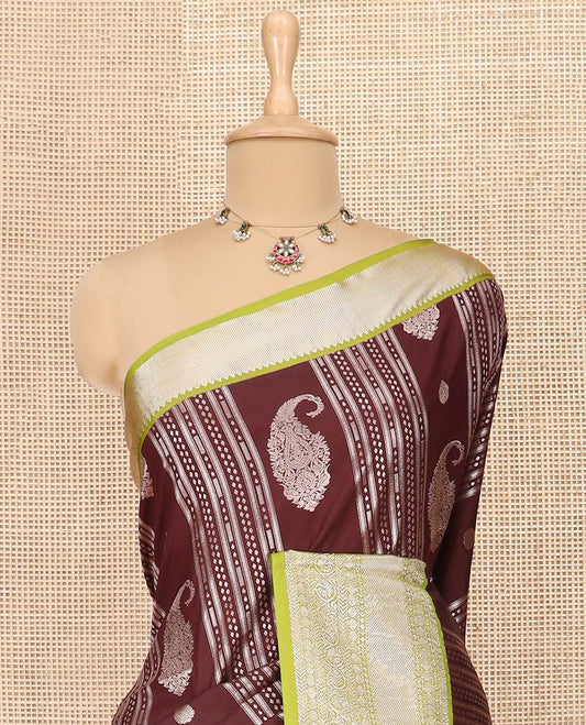 Maroon Semi-Soft Silk Saree Prettified with Paisley and Zari Design, Complemented by Contrast Traditional Zari Design Border, Majestically Detailed Pallu of Intricate Designs, and Paired with a Contrast Blouse