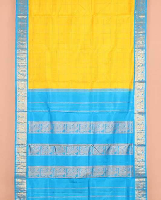 Yellow butta enclosed checked nine-yard silk saree, contrast border of manga mokku, and mayil designs, and pallu of mayil designs