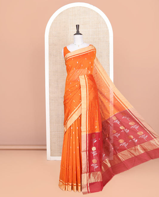 Orange Chanderi Cotton Saree, Decked Up with Buttas All Over Its Body, Highlighted by a Zari Border, Contrast Pallu Steeped with Floral Buttas, and Paired with a Contrast Blouse
