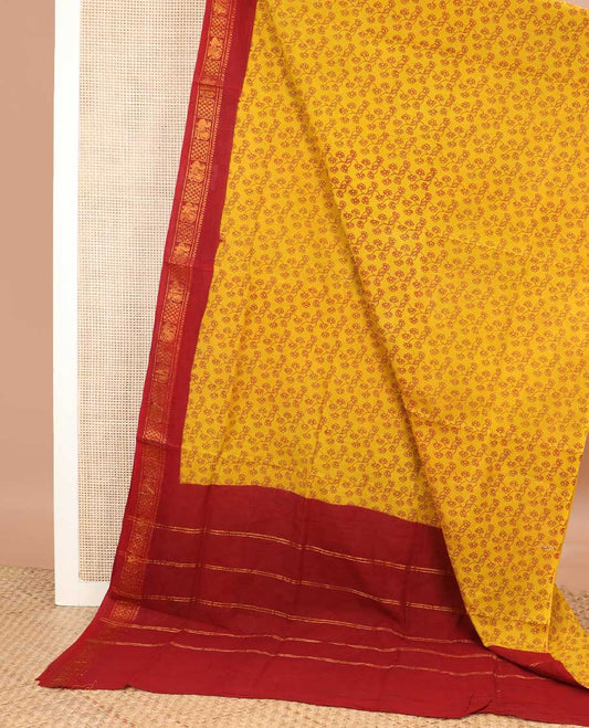 Yellow floral vine printed sungudi cotton saree, contrast traditional zari border, and zari striped pallu
