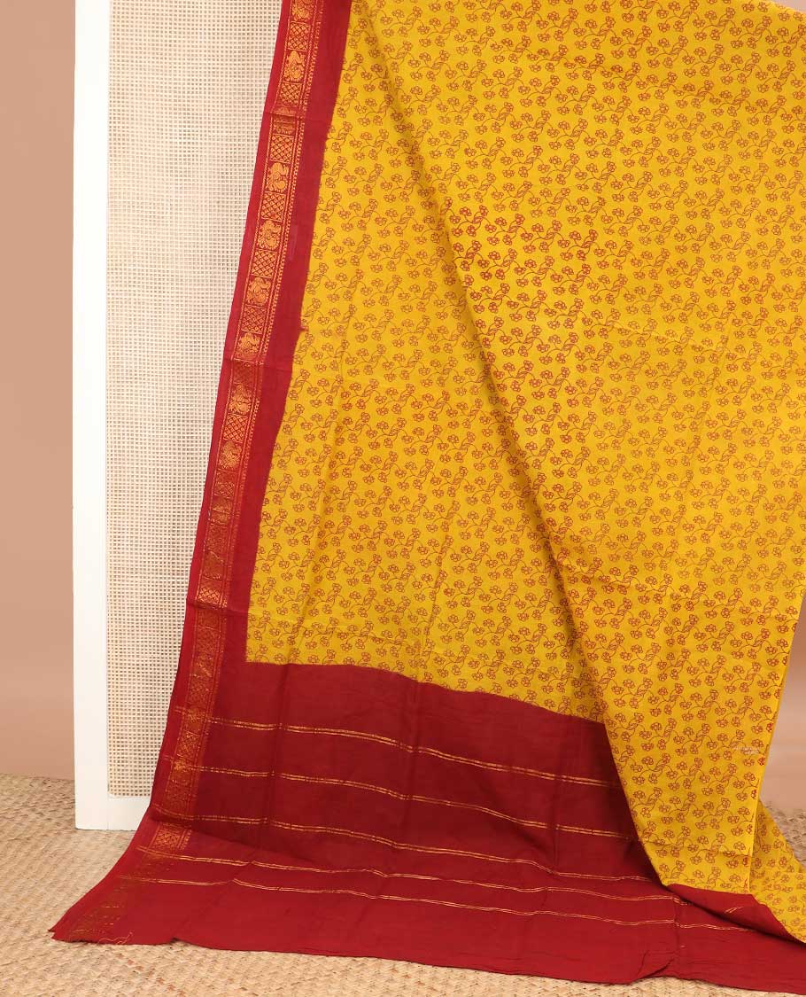 Yellow floral vine printed sungudi cotton saree, contrast traditional zari border, and zari striped pallu
