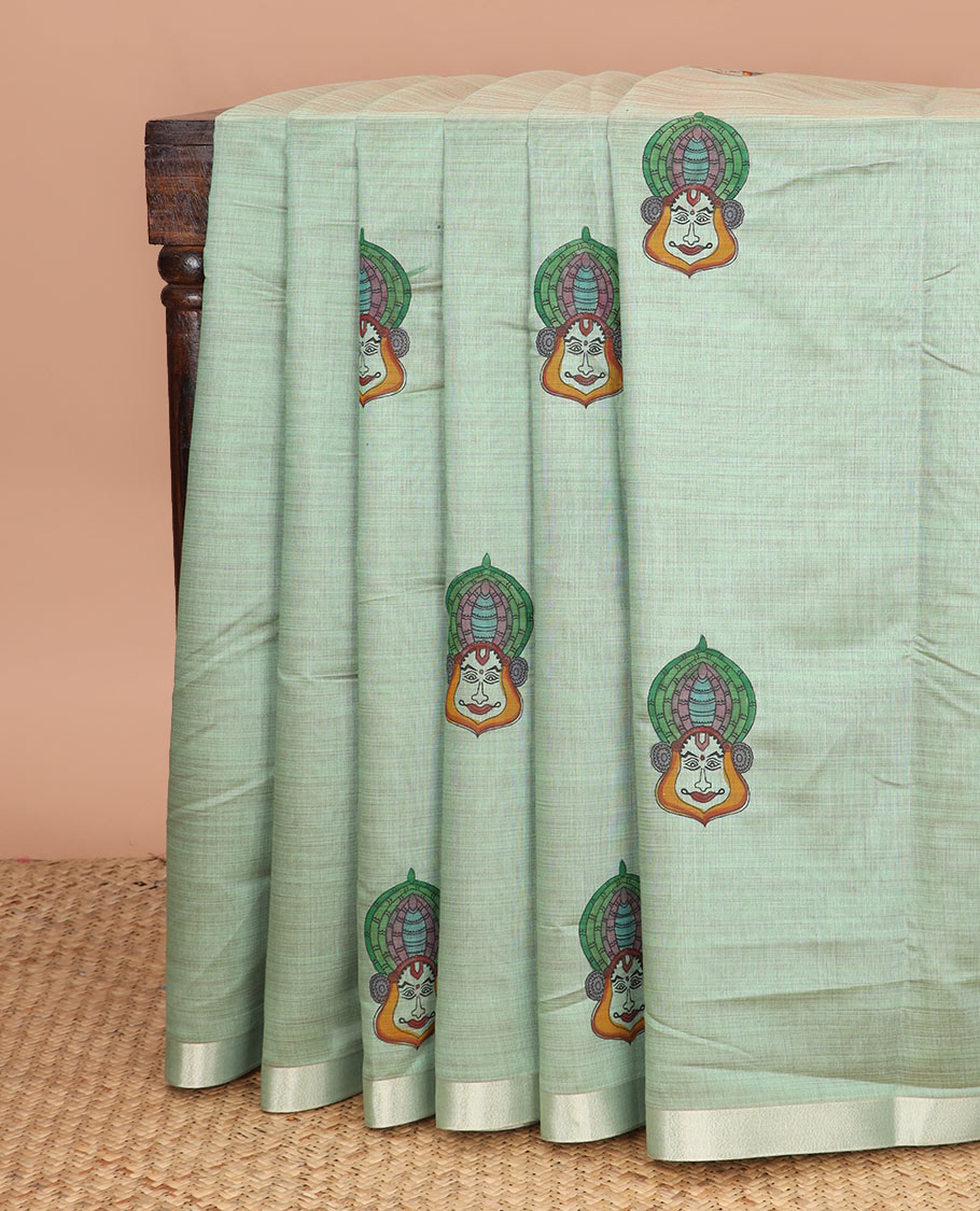 Pale green kalamkari buttas printed chirala cotton saree, bavanji border, and contrast floral vine print pallu