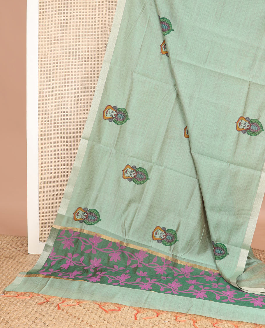Pale green kalamkari buttas printed chirala cotton saree, bavanji border, and contrast floral vine print pallu
