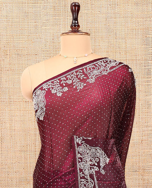 Wine Designer Saree, Scintillated with Stone Struck All Over Its Body, Highlighted by Intricate Stone Work Border, and Paired with a Matching Blouse