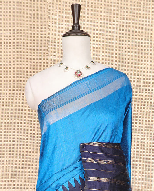 Blue Plain Dupion Silk Saree, Complemented by a Contrast Temple Border of Geometric Patterns, Zari-Rich Pallu of Temple Designs, and Paired with a Contrast Blouse