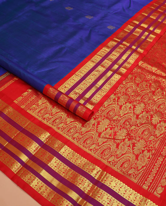 Blue zari buttas Kanchipuram silk saree, contrast one-sided varisai pettu border of thilakam mokku, rudraksham, and mayil designs, and floral jaal pallu
