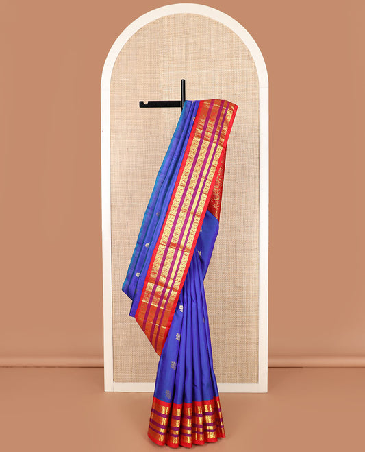 Blue zari buttas Kanchipuram silk saree, contrast one-sided varisai pettu border of thilakam mokku, rudraksham, and mayil designs, and floral jaal pallu