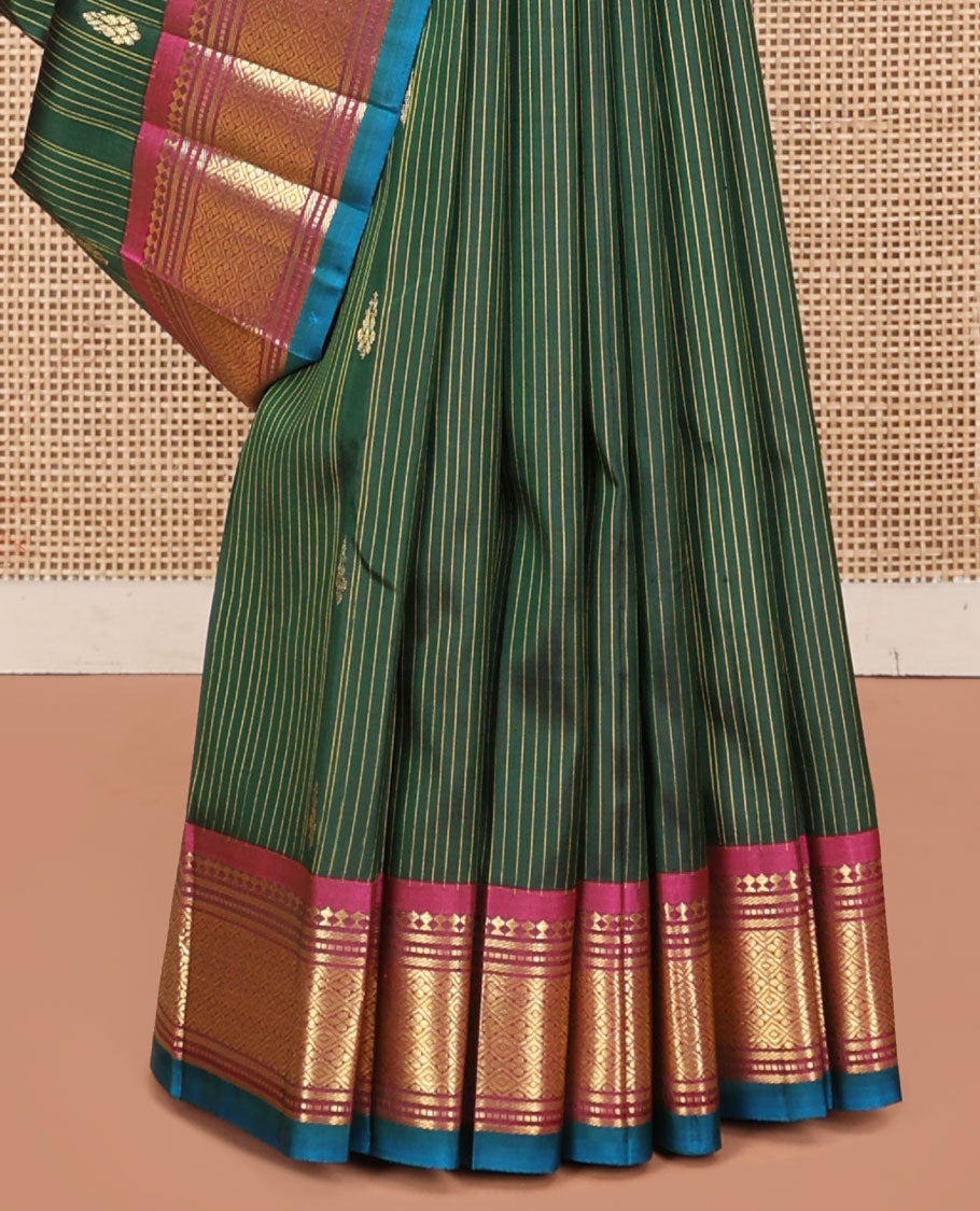 Green Kanchipuram Silk Saree, Adorned with Stripes and Zari Buttas, a Contrast One-Sided Border of Panner Sombu, Banaras, Muthu, and Jaal Design, Zari Design Pallu, and No Blouse