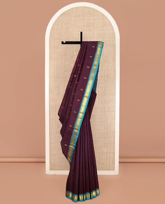 Brown Kanchipuram Silk Saree, Gleamed Up with Zari Buttas on Its Body, Complemented by a Contrast One-Sided Border of Banaras and Jaal Designs, Pallu of Zari Designs, and Comes Without a Blouse