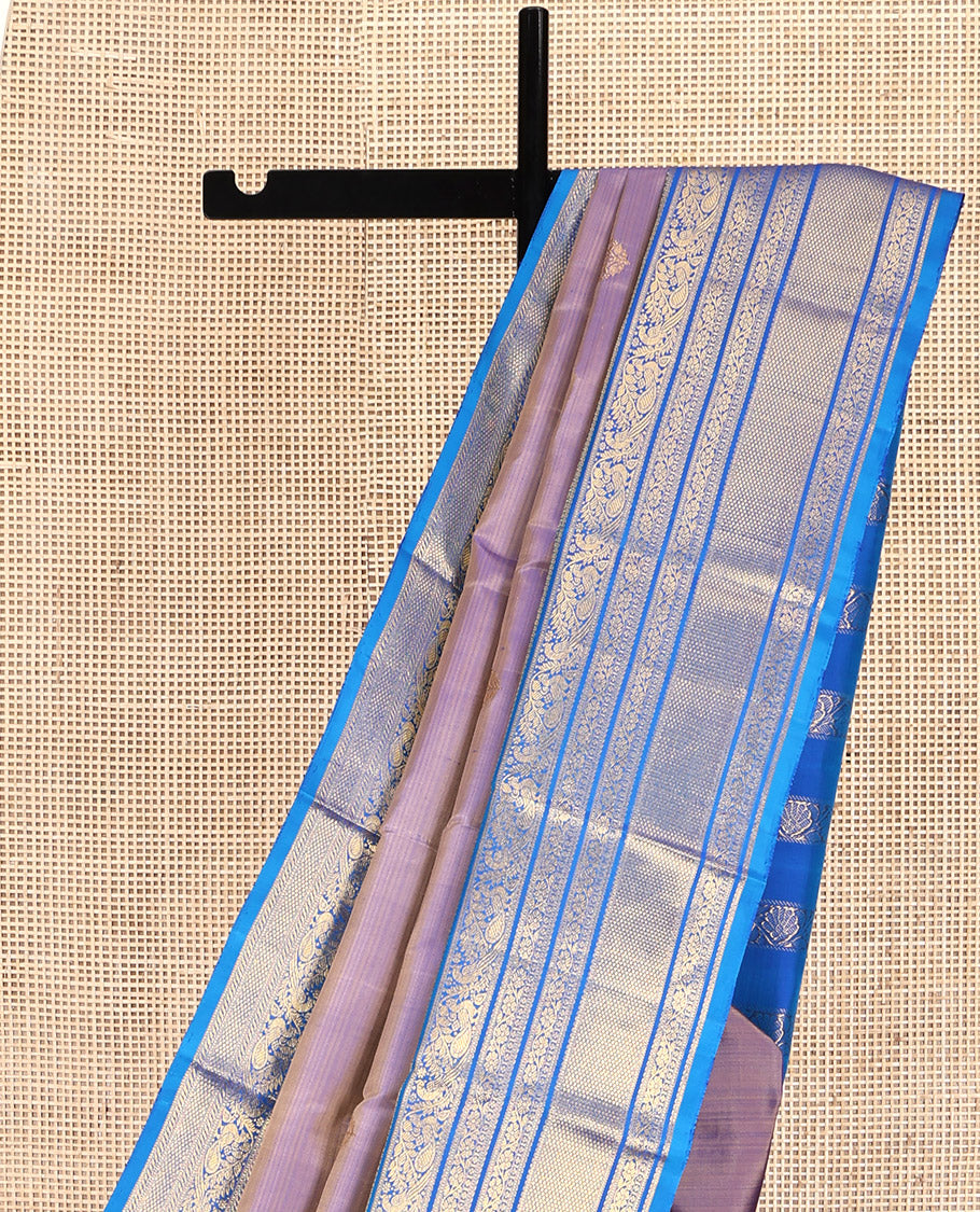 Blue Dual-Tone Kanchipuram Silk Saree, Detailed with Zari Buttas All Over Its Body, Complemented by a Contrast Border of Thilakam Mokku, Kodi Visiry, Mayil, and Kuyil Kann Designs, Grand Pallu of Kodi Visiry Designs, and Paired with a Contrast Blouse