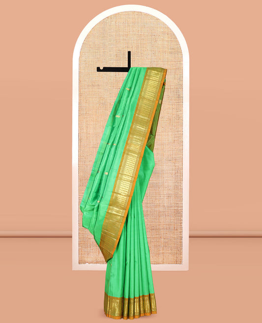 Green Kanchipuram Silk Saree, Styled with Zari Buttas, a Contrast One-Sided Border of Rekku, Banaras, and Rudraksham Designs, Zari Design Pallu, and a No Blouse
