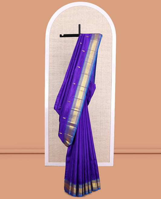 Violet Kanchipuram Silk Saree, Embellished with Zari Buttas, a Contrast One-Sided Border of Paneer Sombu, Banaras, Muthu and Mayil Kann Design, Zari Design Pallu, and No Blouse