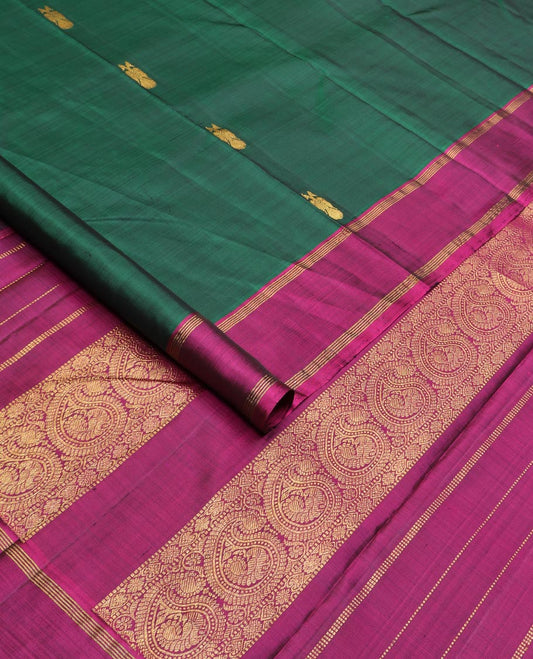 Green iruthalai pakshi buttas Kanchipuram silk saree, contrast rettai pettu border, and pallu of muthu stripes, and arumbu manga designs