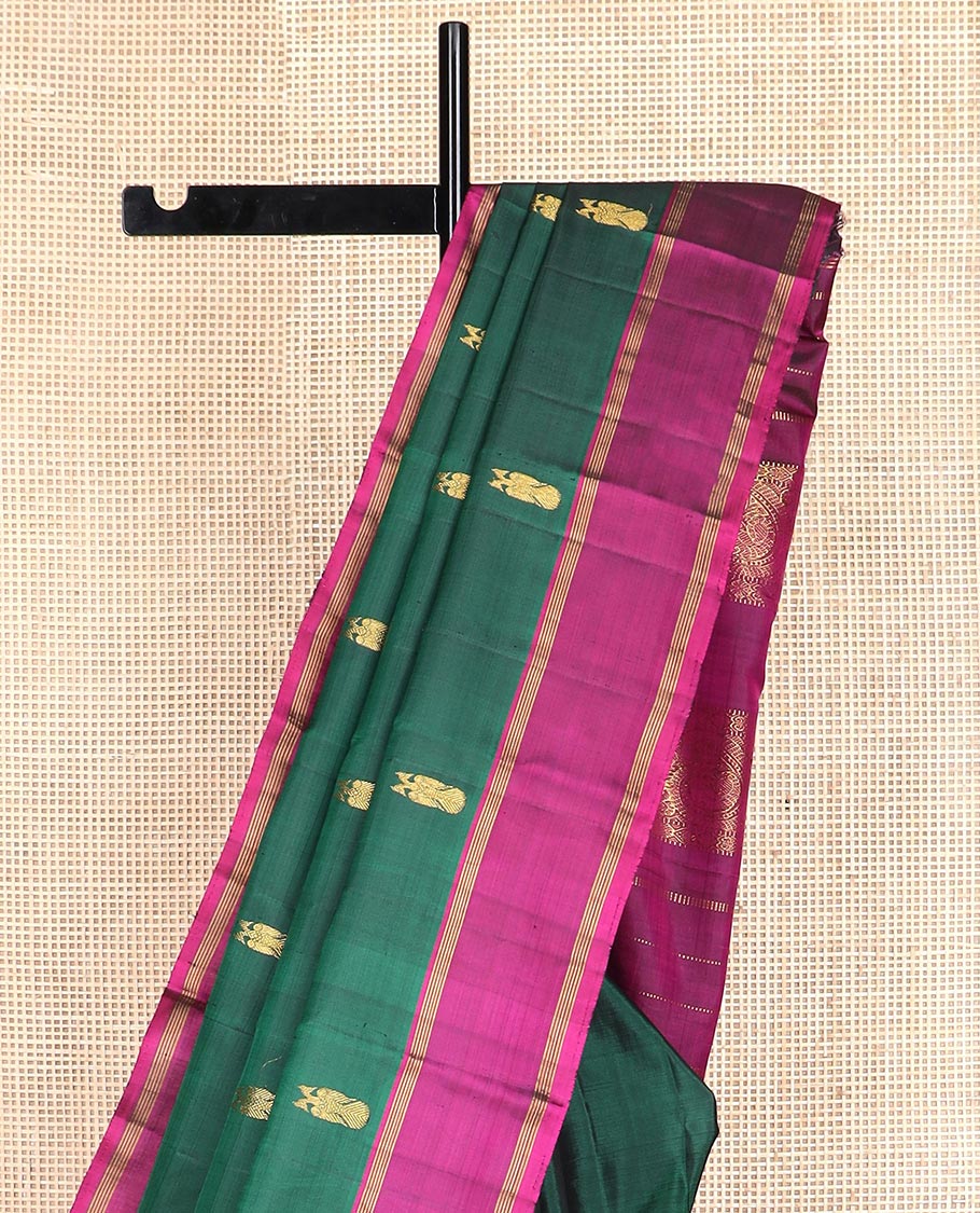 Green iruthalai pakshi buttas Kanchipuram silk saree, contrast rettai pettu border, and pallu of muthu stripes, and arumbu manga designs