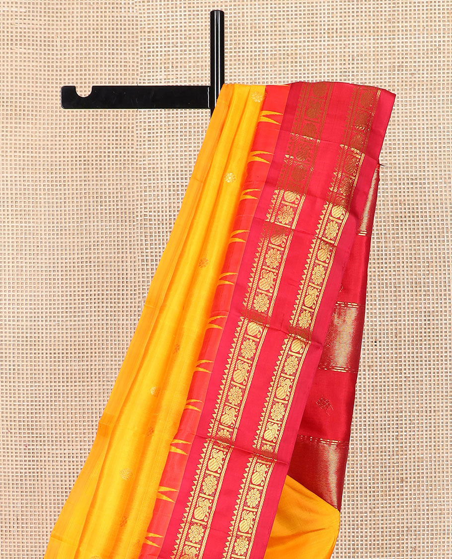 Yellow zari buttas Kanchipuram silk saree, contrast thazampoo rekku border of rekku, banaras, and mayil chakram designs, and zari design pallu