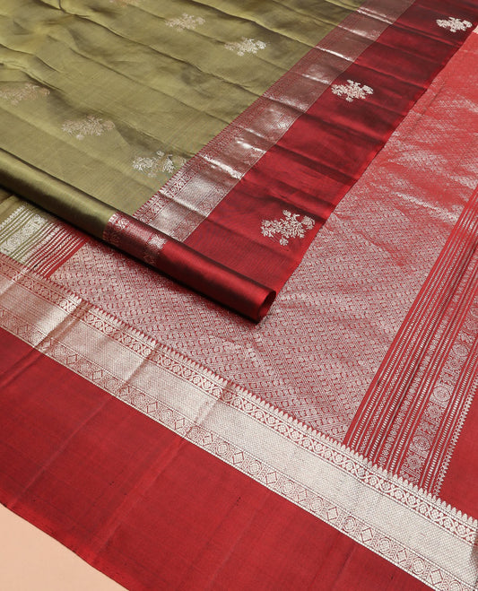 Green zari buttas Kanchipuram silk saree, contrast border of thilakam, muthu, kodi visiry, mayil kann, chakra, and diamond designs, and rudraksham motifs pallu