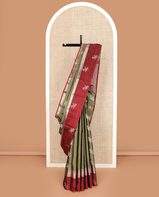 Green zari buttas Kanchipuram silk saree, contrast border of thilakam, muthu, kodi visiry, mayil kann, chakra, and diamond designs, and rudraksham motifs pallu