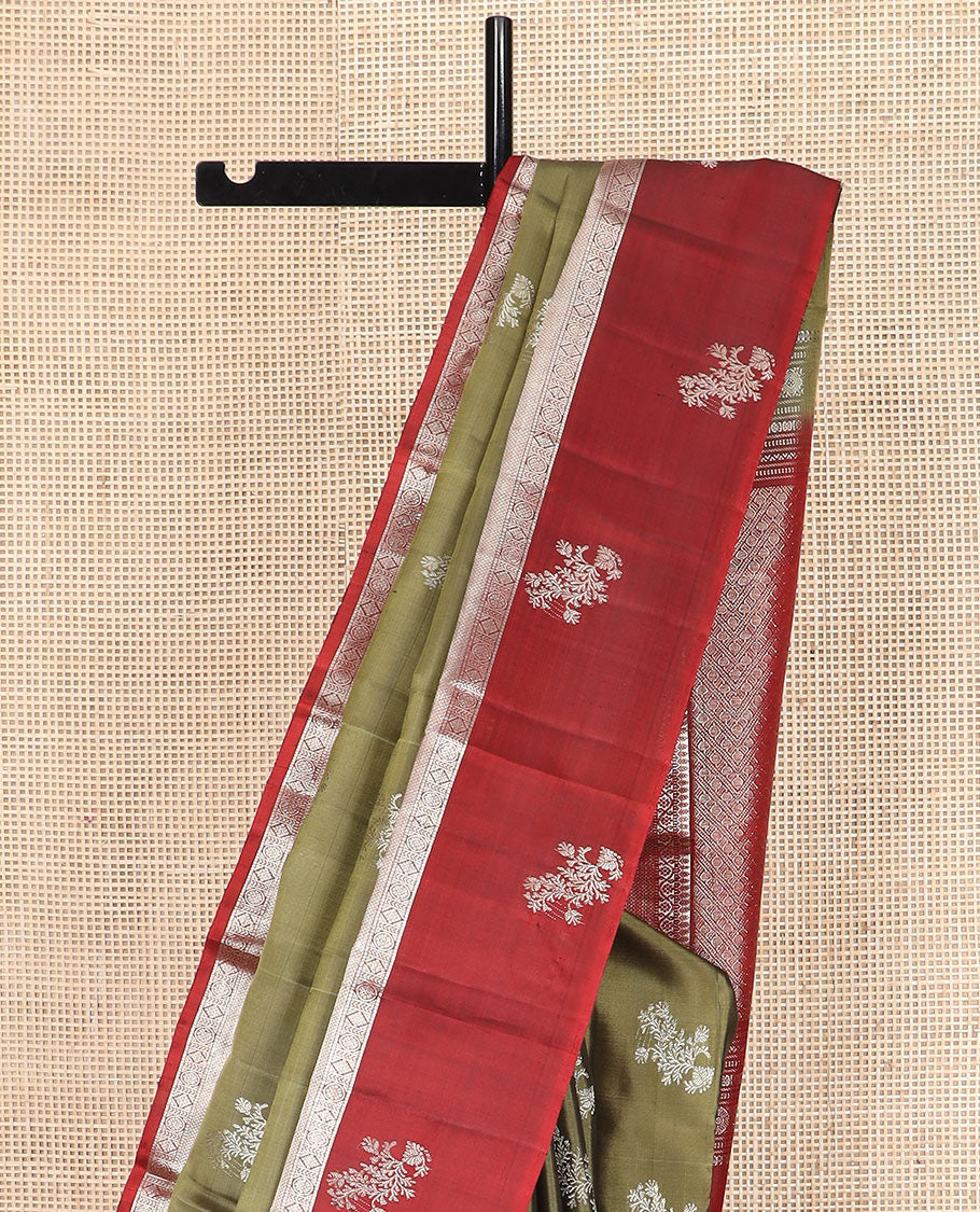 Green zari buttas Kanchipuram silk saree, contrast border of thilakam, muthu, kodi visiry, mayil kann, chakra, and diamond designs, and rudraksham motifs pallu