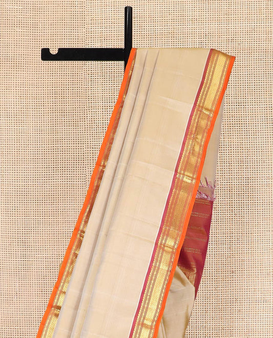 Light Sandal Plain Kanchipuram Silk Saree, Complemented by Contrast Border of Salngai, Muthu, Lavangam, and Vanki Designs, Zari Woven Pallu, and Paired with a Contrast Blouse