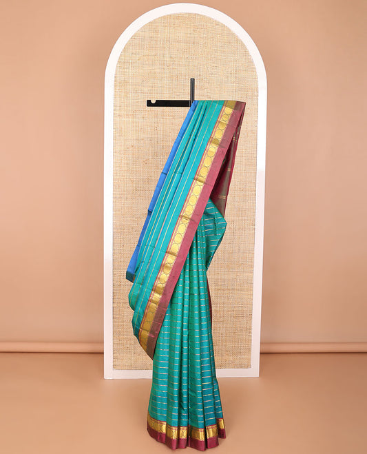 Dark blue striped kancheepuram with contrast border of paisley, muthu, kathir design & zari design pallu