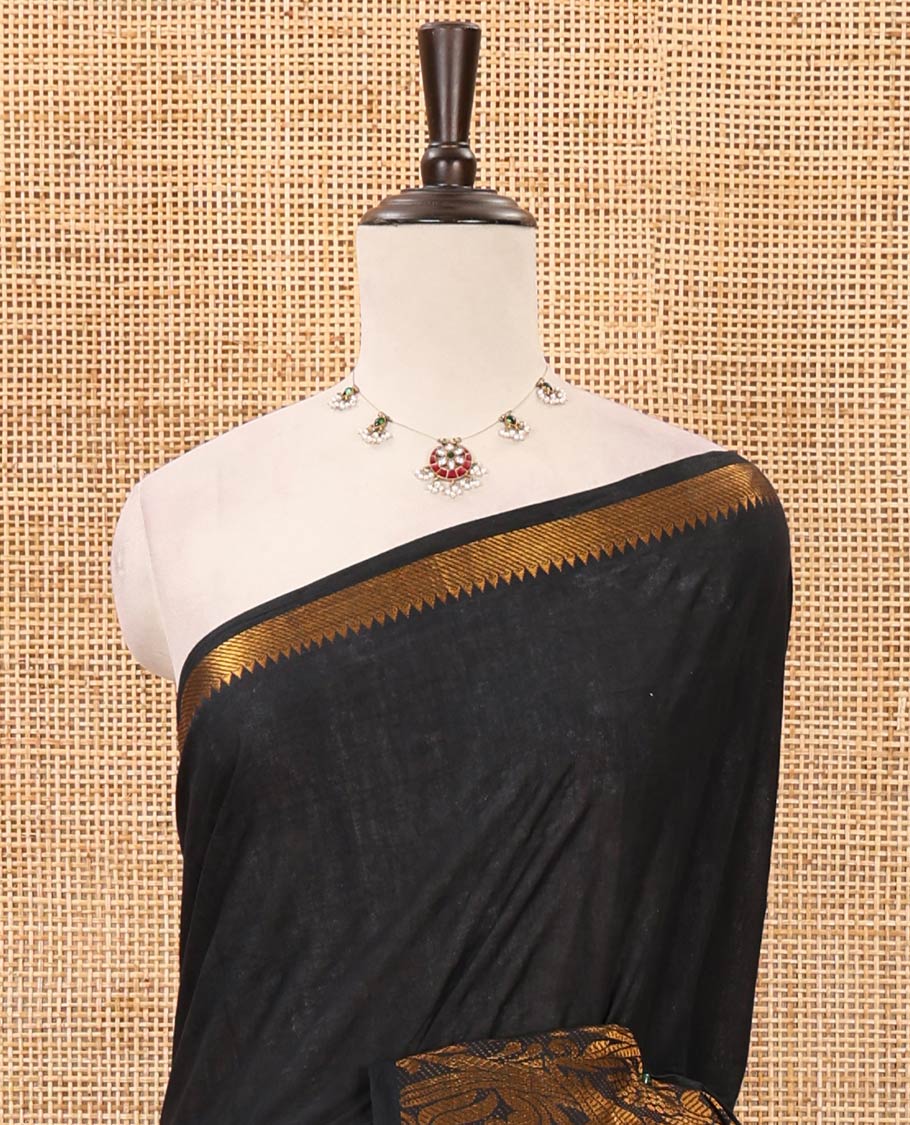 Dark green plain sungudi cotton saree, temple border of floral & bird zari designs, zari striped pallu & contrast orange jacquard blouse