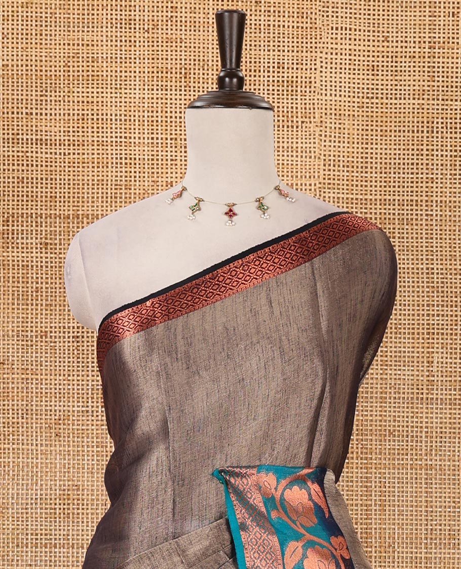 Navy blue plain tissue saree, contrast floral creeper & diamond patterned zari border, striped pallu & contrast plain blouse