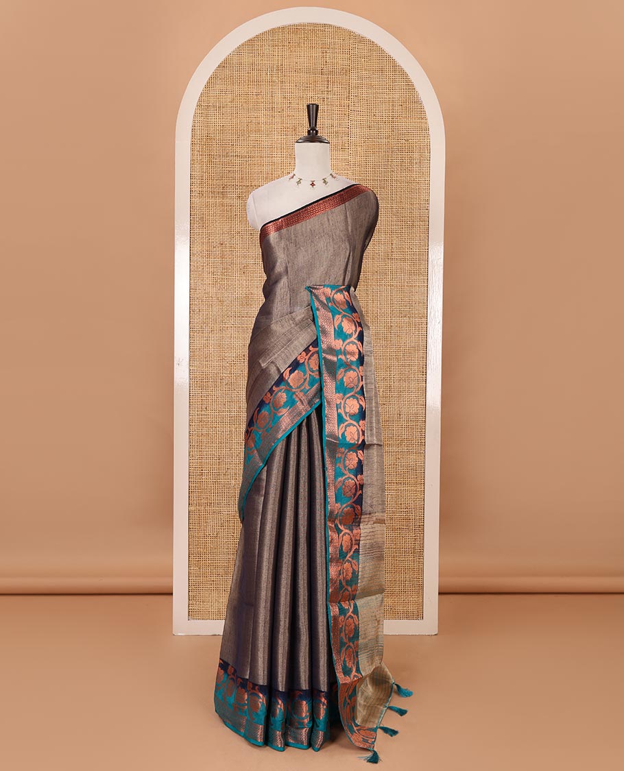Navy blue plain tissue saree, contrast floral creeper & diamond patterned zari border, striped pallu & contrast plain blouse