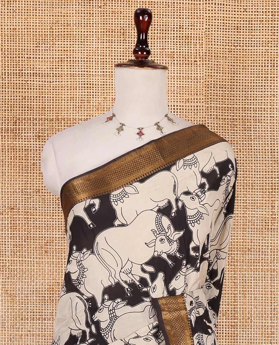 Black and cream pichwai cow printed Mangalagiri silk saree, traditional zari design border, kalamkari printed pallu, and printed blouse