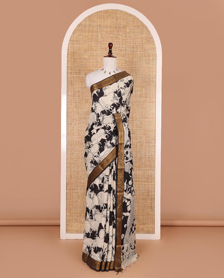 Black and cream pichwai cow printed Mangalagiri silk saree, traditional zari design border, kalamkari printed pallu, and printed blouse