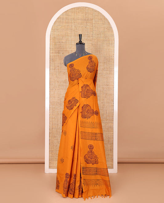 Borderless yellow kolam and kathakali motifs printed South cotton saree with a matching blouse, and a contrast floral vine printed blouse