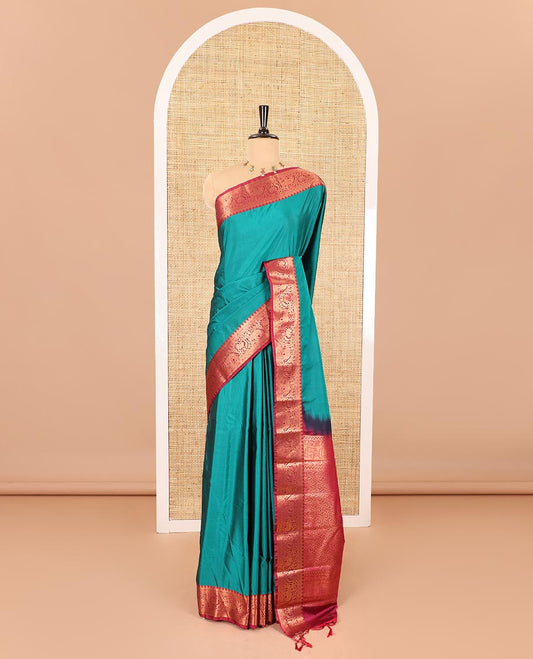 Peacock green plain luxury soft silk saree, contrast traditional temple zari border of elephant motifs, geometric zari pallu, and a contrast jacquard blouse