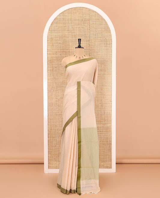 Cream-olive green plain mercerised cotton saree,contrast plain  border, striped pallu, and a contrast plain blouse