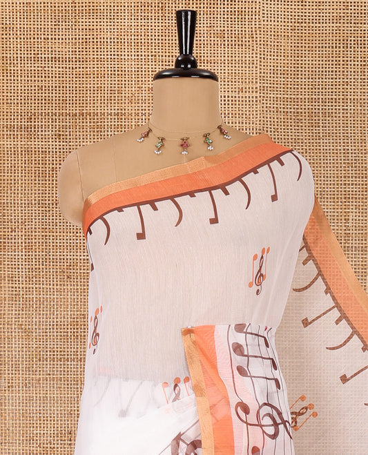White and orange musical note motifs printed Chanderi cotton saree, zari piping border, geometric printed pallu, and a unique motifs printed blouse