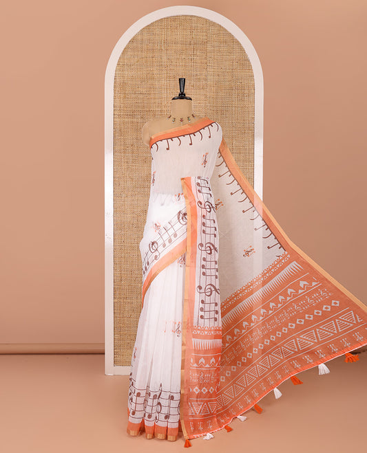 White and orange musical note motifs printed Chanderi cotton saree, zari piping border, geometric printed pallu, and a unique motifs printed blouse