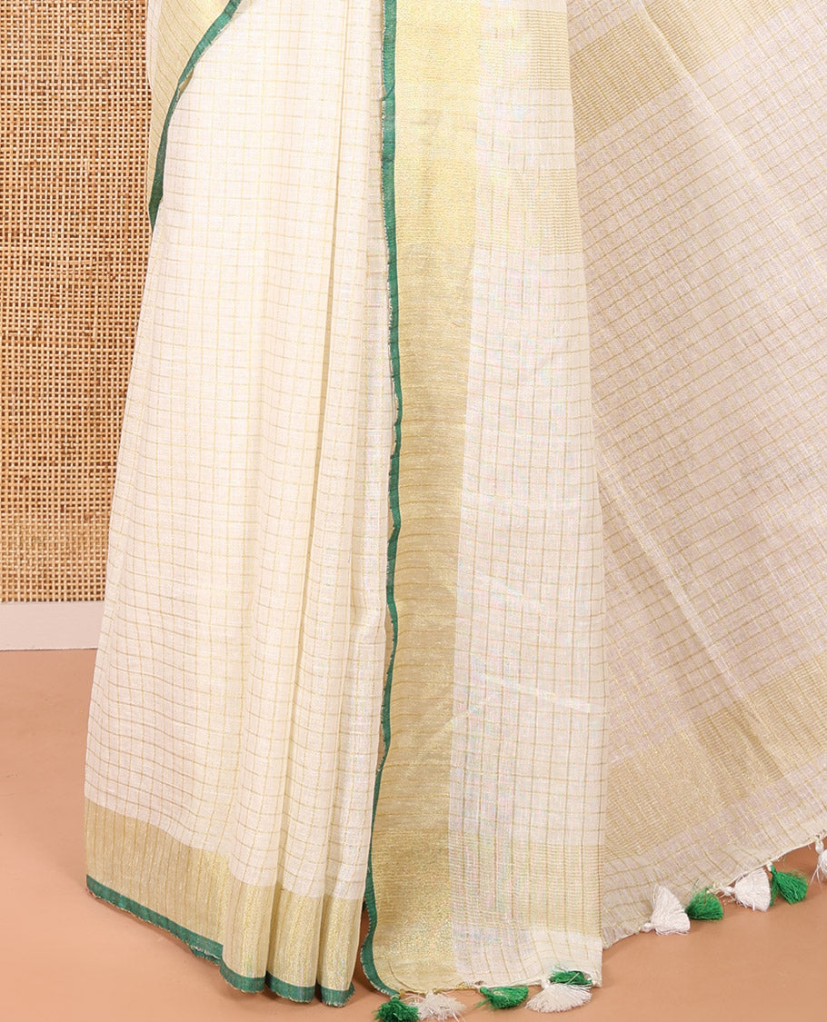 Cream and Green Linen Saree Sparsely Sparkled with Checks, Subtly Designed Zari Border, Zari Striped Pallu, and Paired with a Contrast Blouse