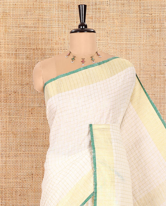 Cream and Green Linen Saree Sparsely Sparkled with Checks, Subtly Designed Zari Border, Zari Striped Pallu, and Paired with a Contrast Blouse