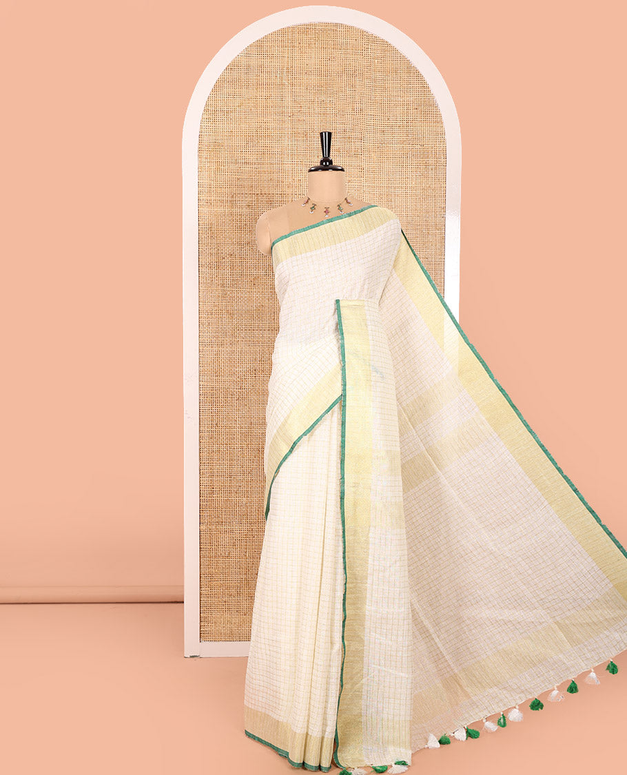 Cream and Green Linen Saree Sparsely Sparkled with Checks, Subtly Designed Zari Border, Zari Striped Pallu, and Paired with a Contrast Blouse